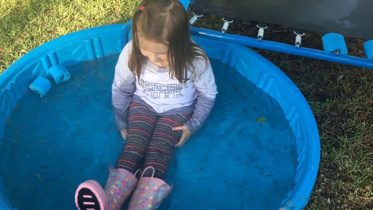 Jumps in the kiddie pool with her clothes on.