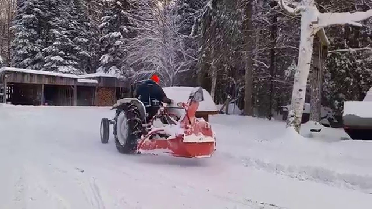 1953 Ford Jubliee Tractor using old pull-behind V-type snowblower (1 of 3).