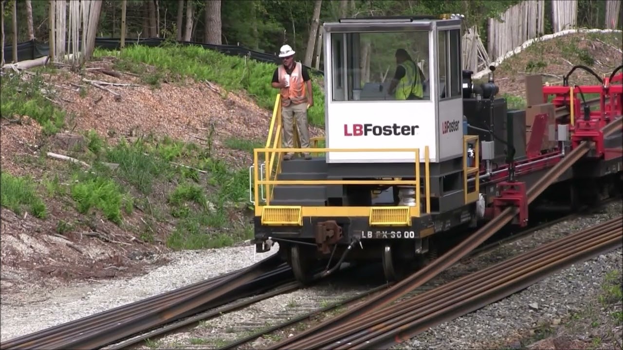 Unloading a continuous welded rail train to rebuild South Coast Rail - Summer 2021