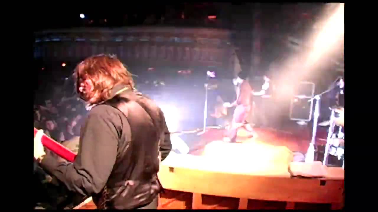 A fan jumps on stage during Build God, Then We'll Talk