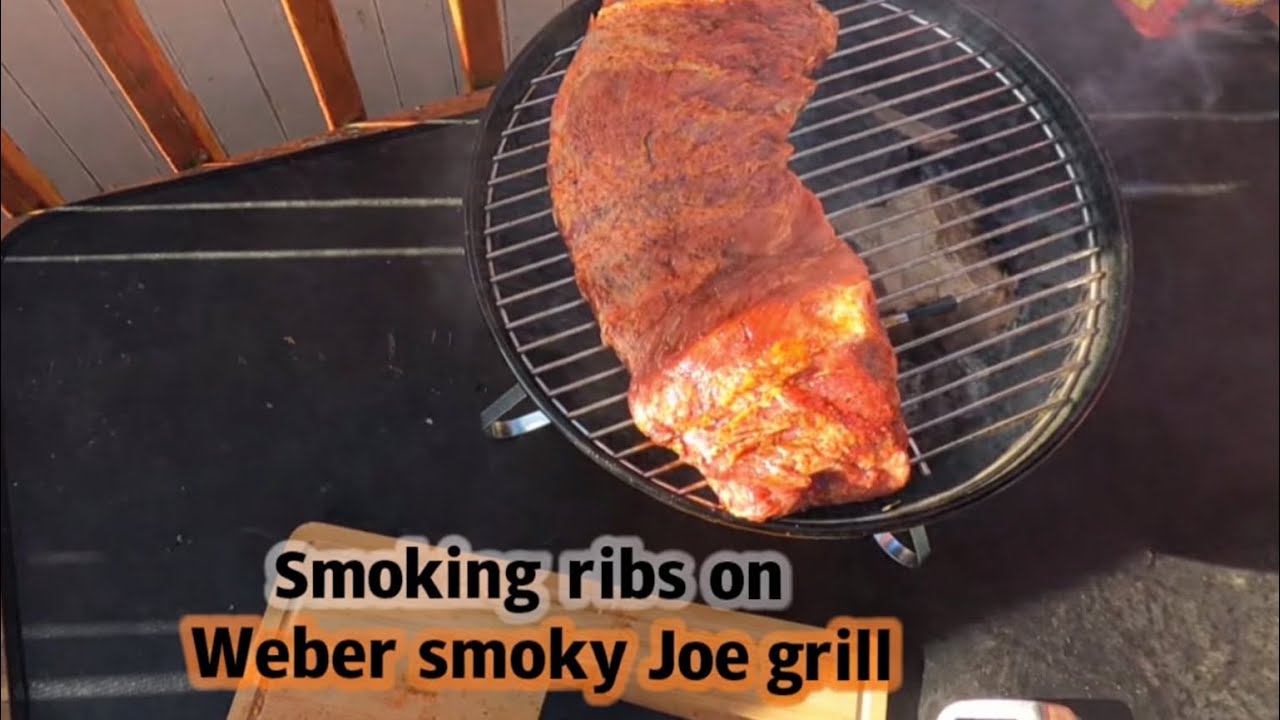 Smoking ribs using weather 14 inch smoky Joe GRILL.￼