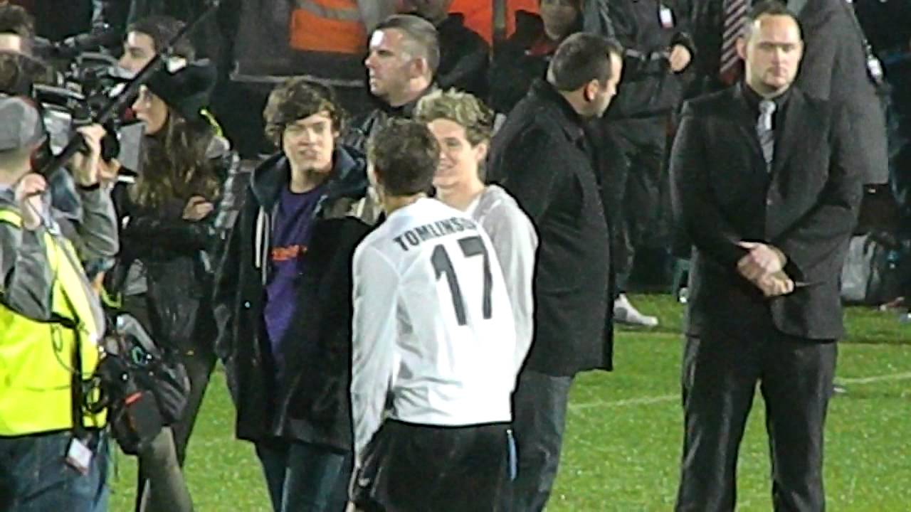 Niall, Harry and Louis on the pitch.