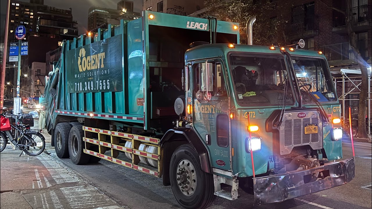 Multiple Cogent rear loader garbage trucks on NYC trash/pallets