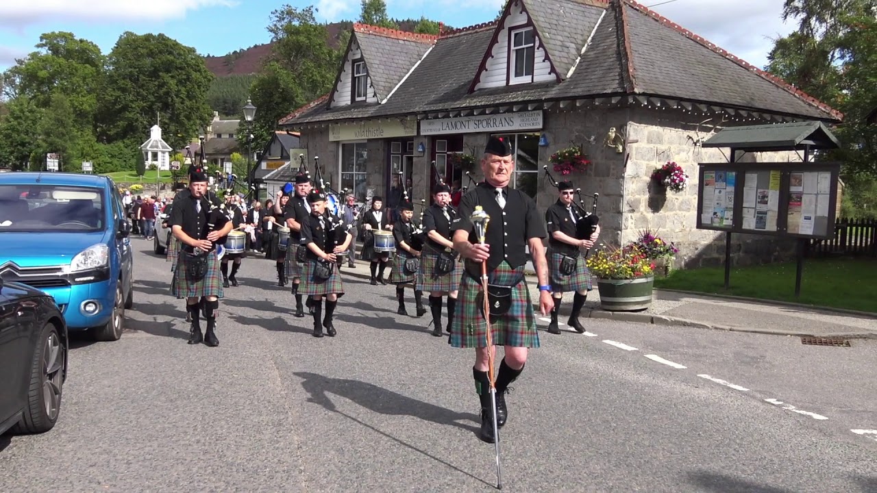 Ellon & District RBL Pipe Band parade through highland village of Braemar, Scotland, Aug 2017