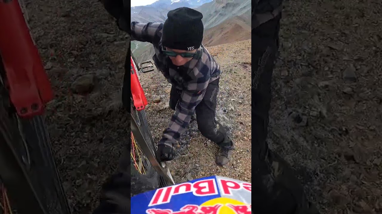 Getting out of Heli on a cliff edge to go Mountain Bike