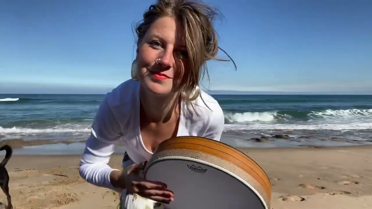 manifesting my dream life by frame drumming on the beach