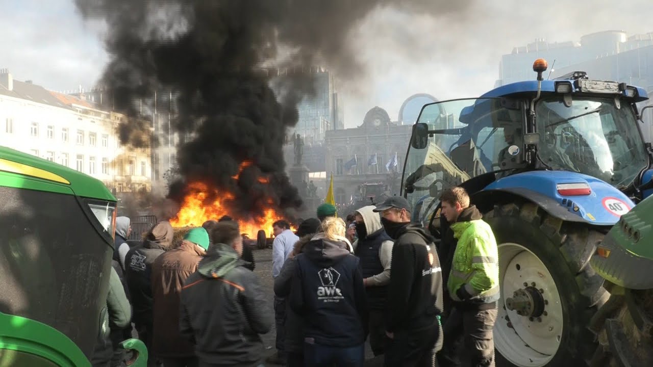 Farmers light fires outside European Parliament building in Brussels | AFP