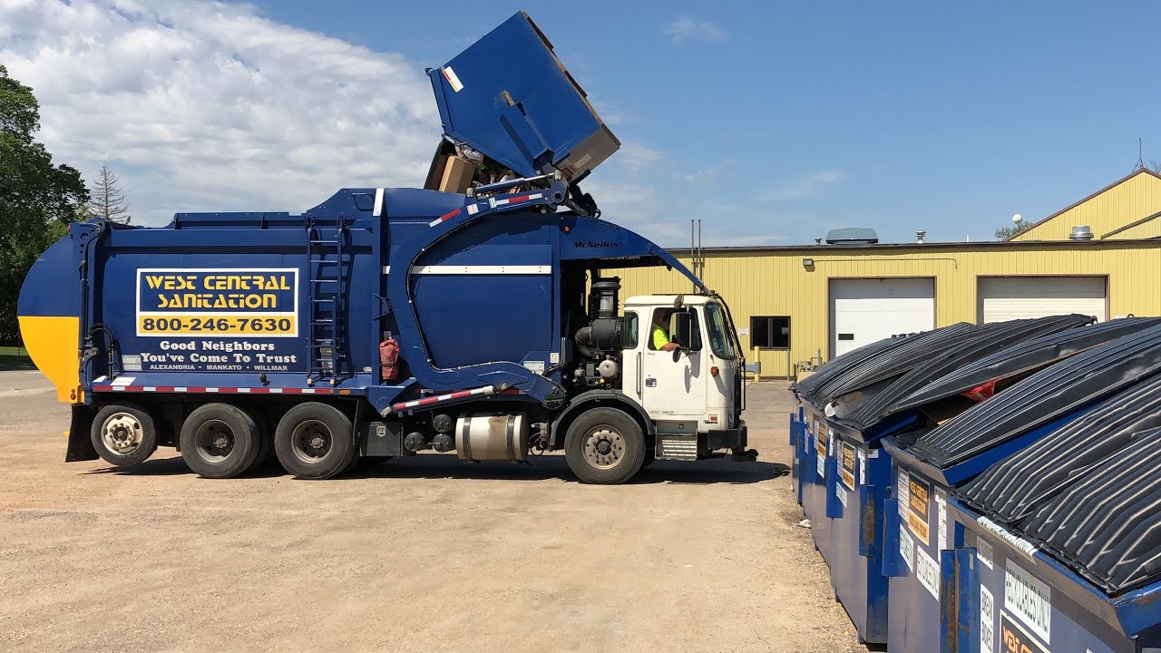 West Central Sanitation Autocar McNeilus Front Loader Garbage Truck on a Dumpster Line