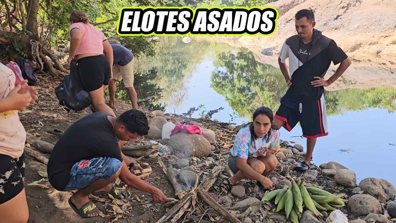 Asando elotes a la orilla del rio.