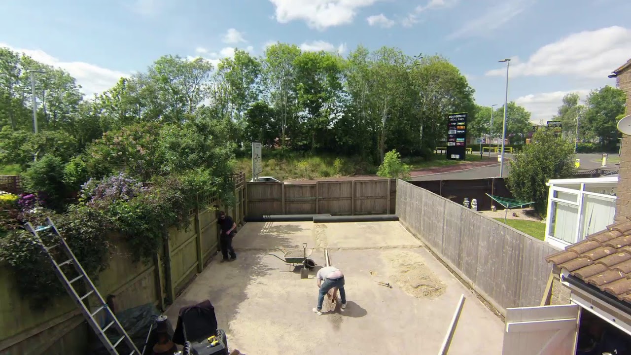 AstroTurf install - Screeding and rolling out the turf ready to be cut and secured.