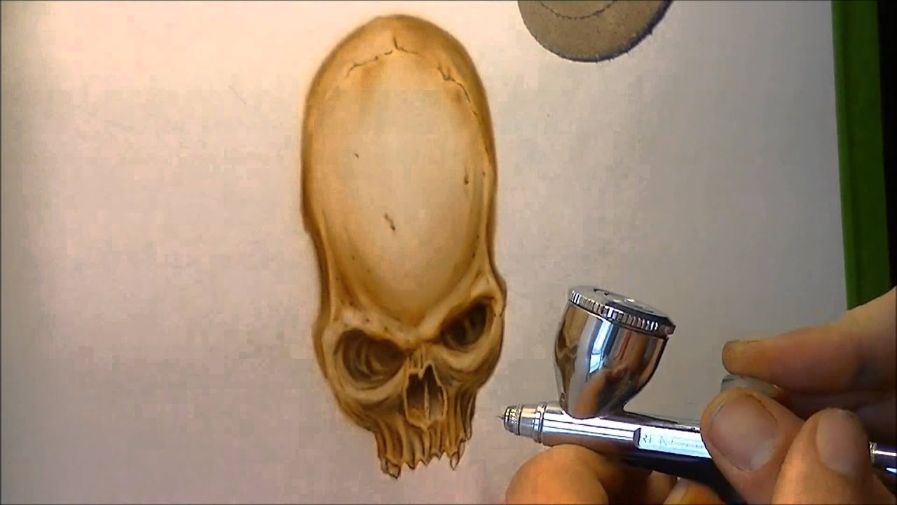 Airbrushing a skull with wings