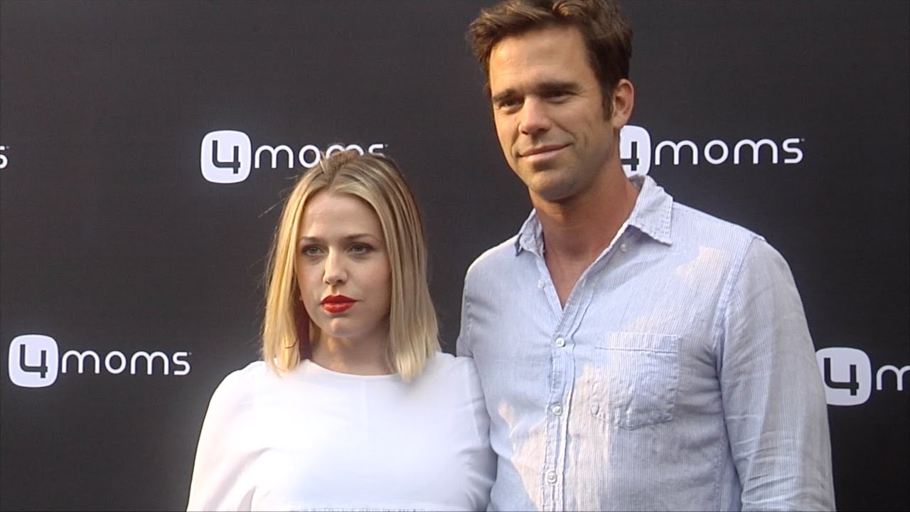 Majandra Delfino & David Walton 4moms Self-Installing Car Seat Launch Black Carpet
