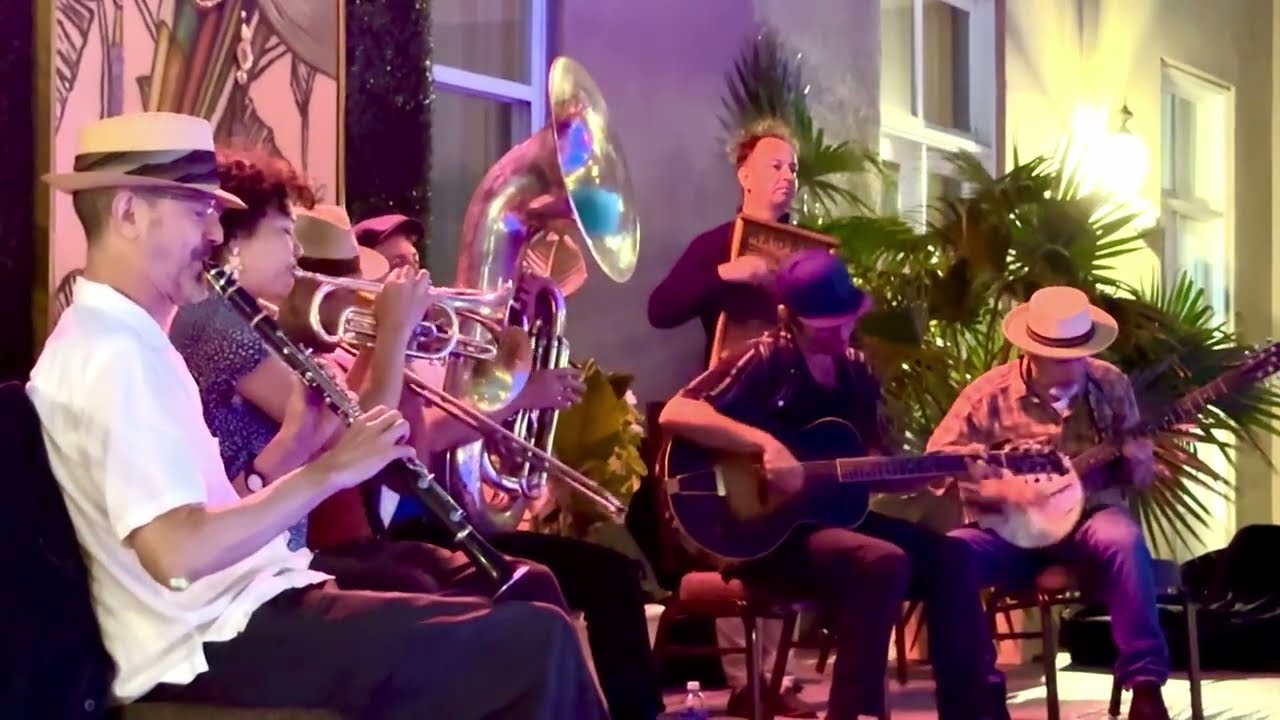 Tuba Skinny around a noisy pool in the French Quarter, New Orleans