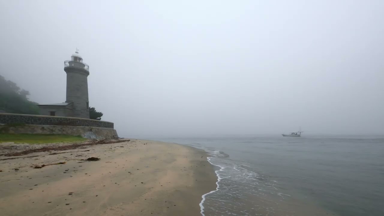 a misty morning by the old lighthouse