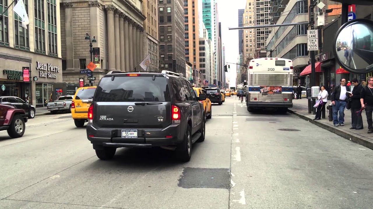 EMTP PRIVATELY OWNED VEHICLE CRUISING BY ON 6TH AVENUE IN MIDTOWN, MANHATTAN IN NEW YORK CITY.