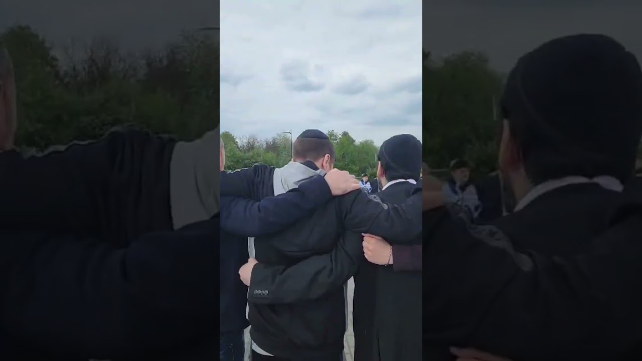 Hasmonean Bochurim singing outside Auschwitz-Birkenau