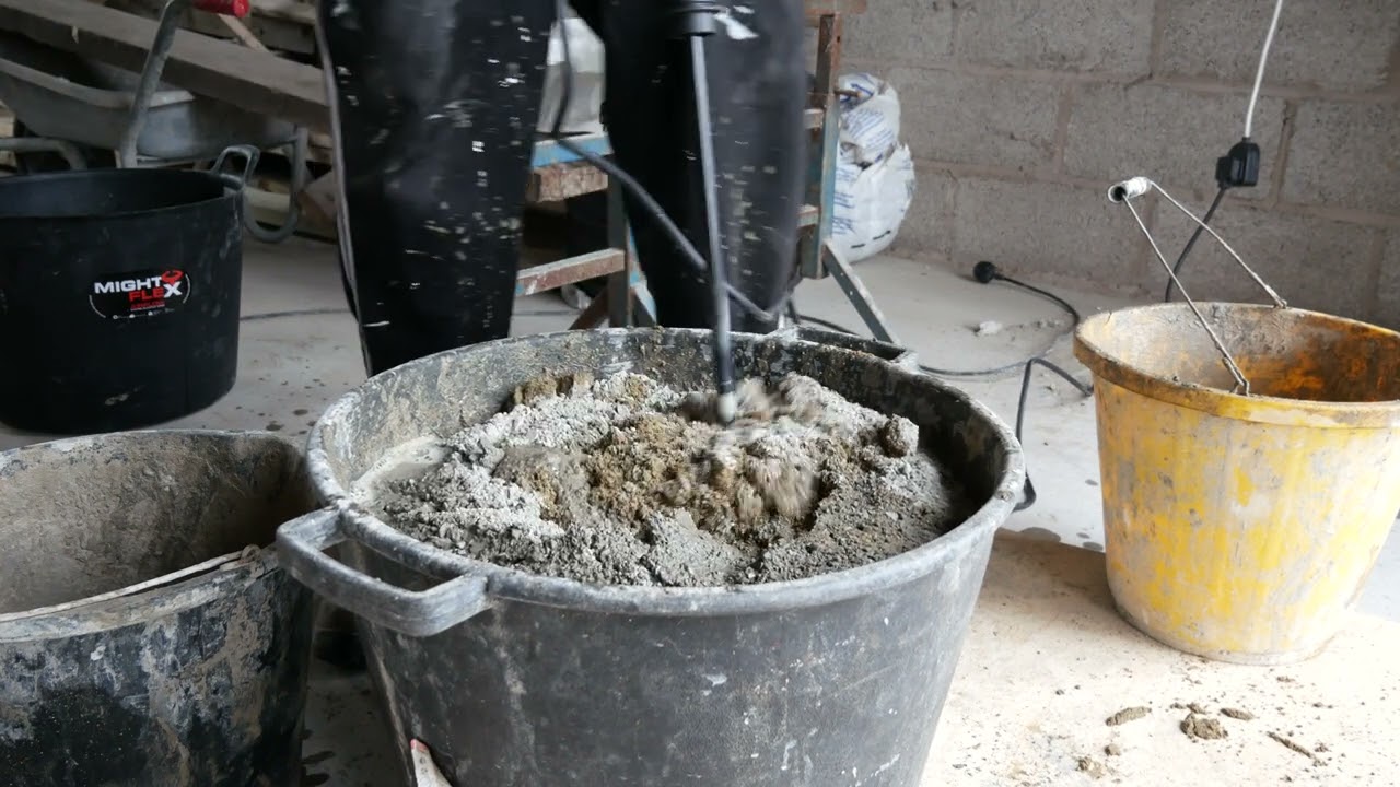 Rubi mixer mixing drill in use on sand and cement render more or less concrete