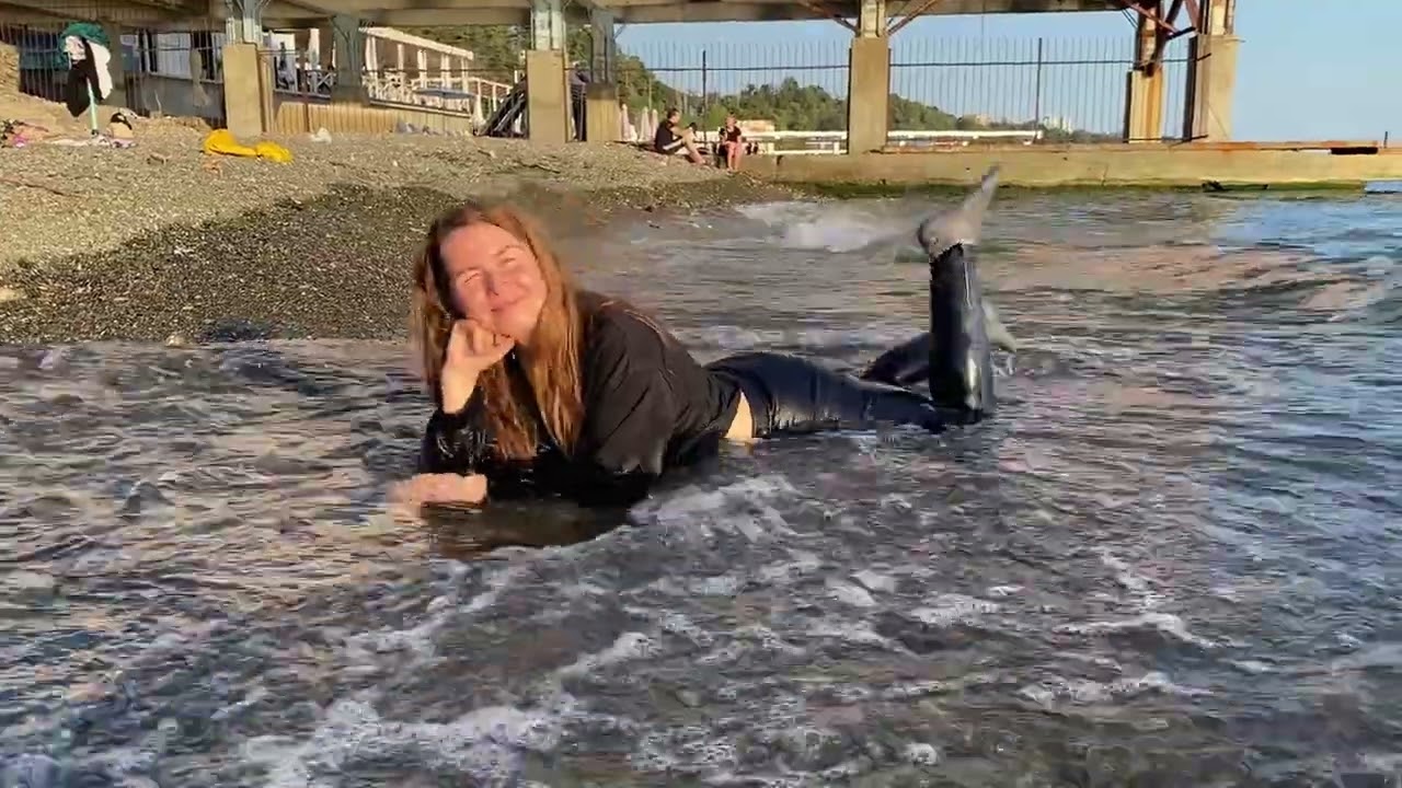 swims in the sea in a hoodie and trousers #wetlook