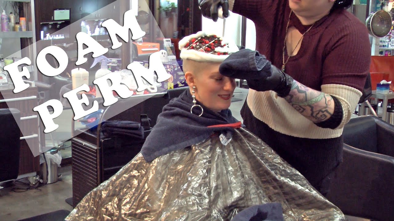 Getting a foam perm with tiny red rods in a hair salon