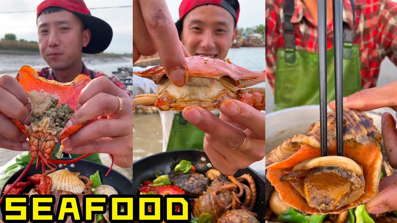 Pria tampan makan makanan laut yang lezat ikan octopathy, kepiting, abalon, kerang laut, udang,