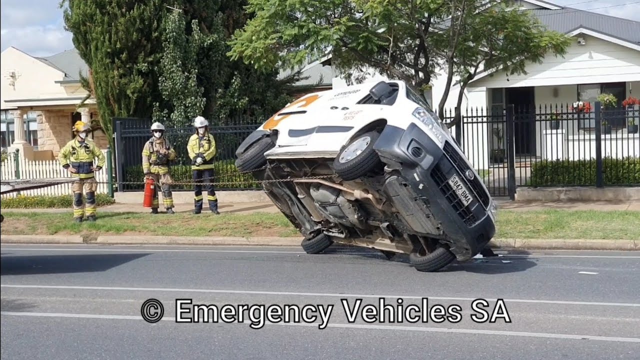 Isuzu tilt tray tow trucks arrive at Fiat van rollover crash to recover damaged vehicles