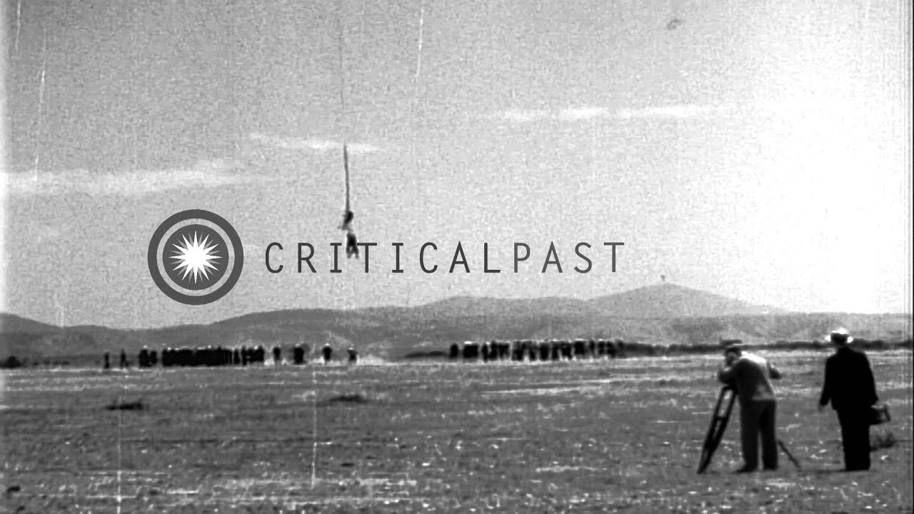 A sailor hanging on a cable attached to USS Akron in flight over Camp Kearny, San...HD Stock Footage