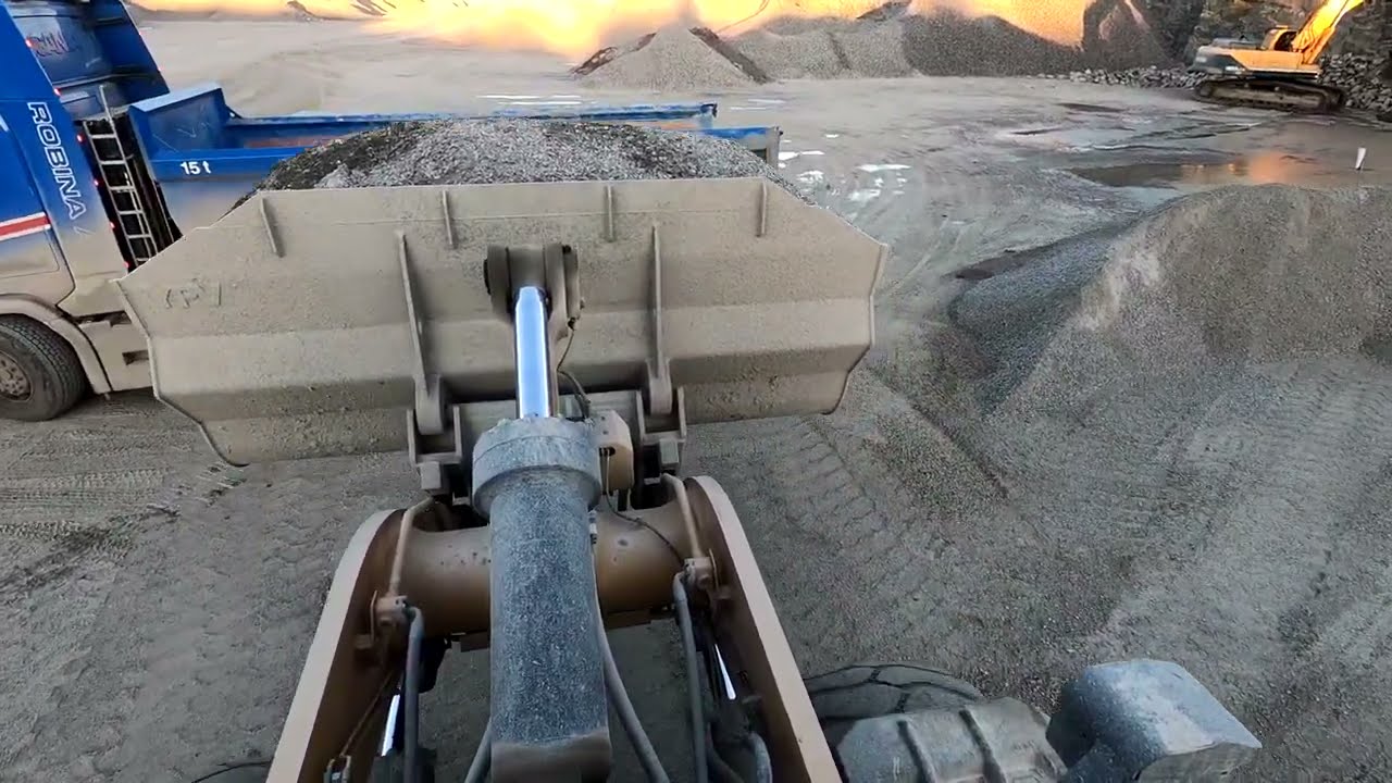A day at work Caterpillar 972M XE wheel loaders loads truck