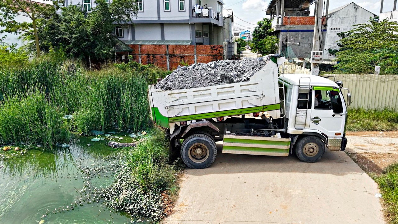 First Start New Project Landfill Flooded area !! Dump Truck Unloading Soil with Mini Bulldozer