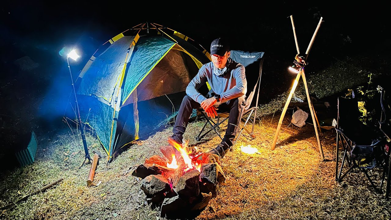 Camping alone one night on the mountain cooking BBQ to eat and see the sunset
