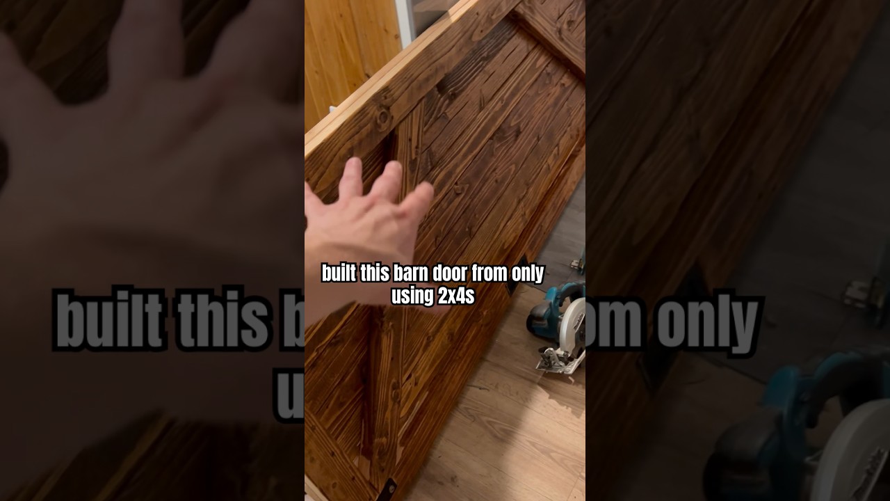 Built a barn door from only using 2x4s,  3.5 inch screws, and oak wood stainer. Total cost $62.50