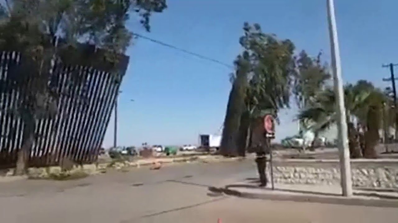 Border wall falls in high winds
