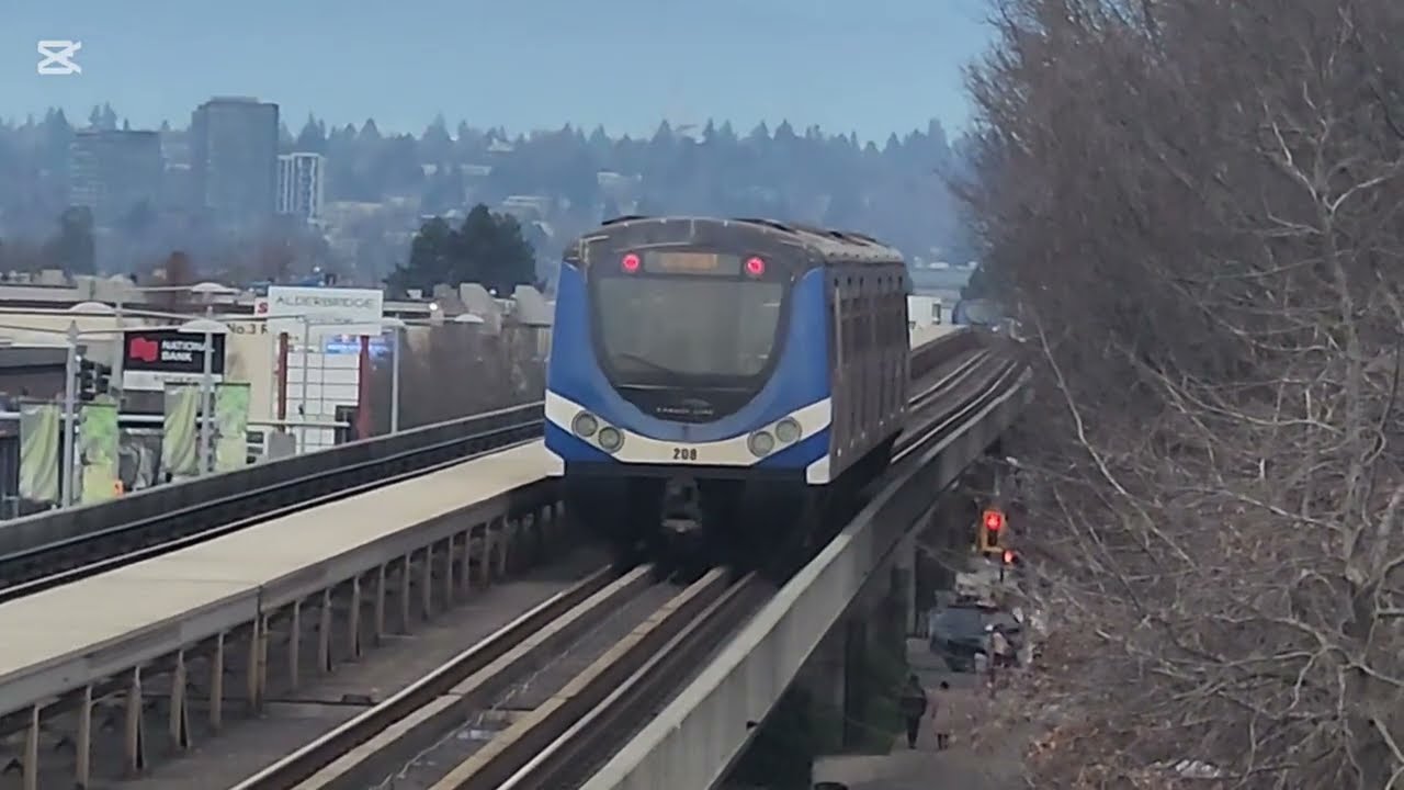Two Canada Line SkyTrain Hyundai Rotems depart and arrive at Lansdowne station