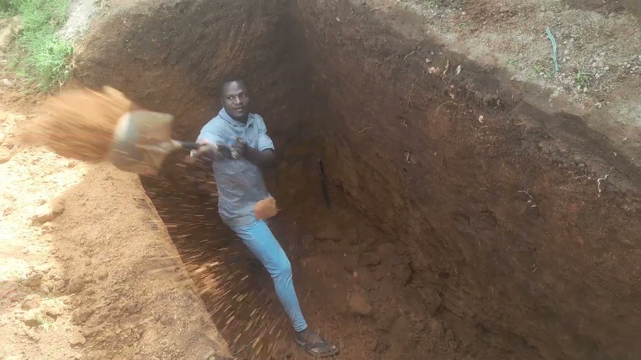 on how to pull out the sand inside the latrine locally in African way 