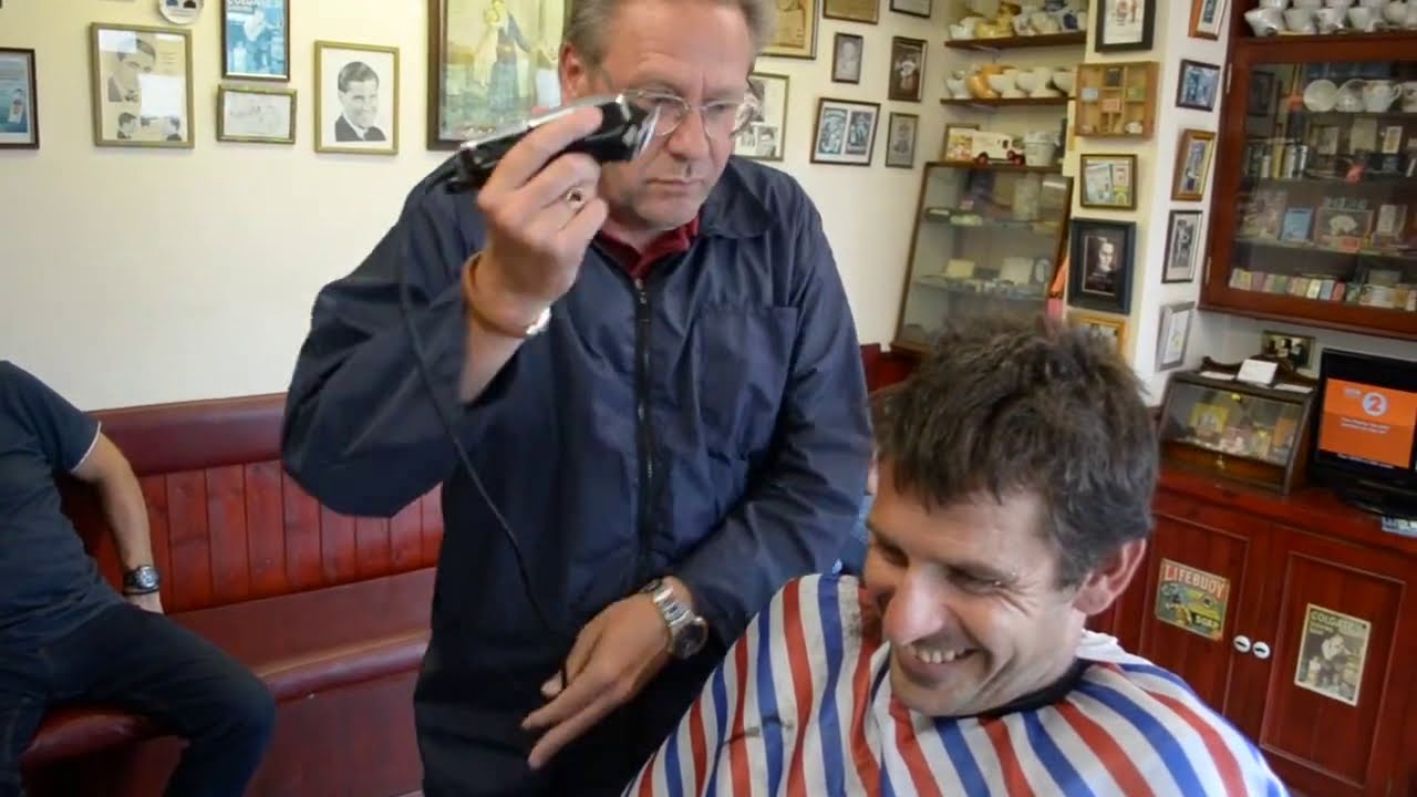 Middle aged guy shaving all of his hair with no guard for charity!