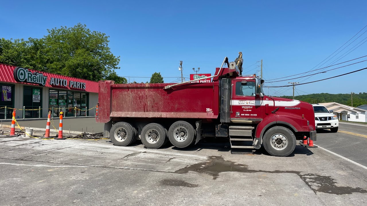 A CAT 308E2 loading a western star dump truck in Woodbury, TN