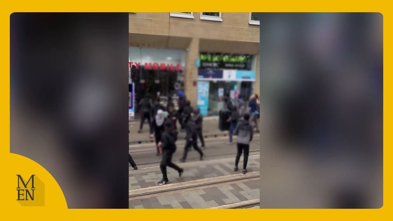 Moment masked mob storm Manchester city centre
