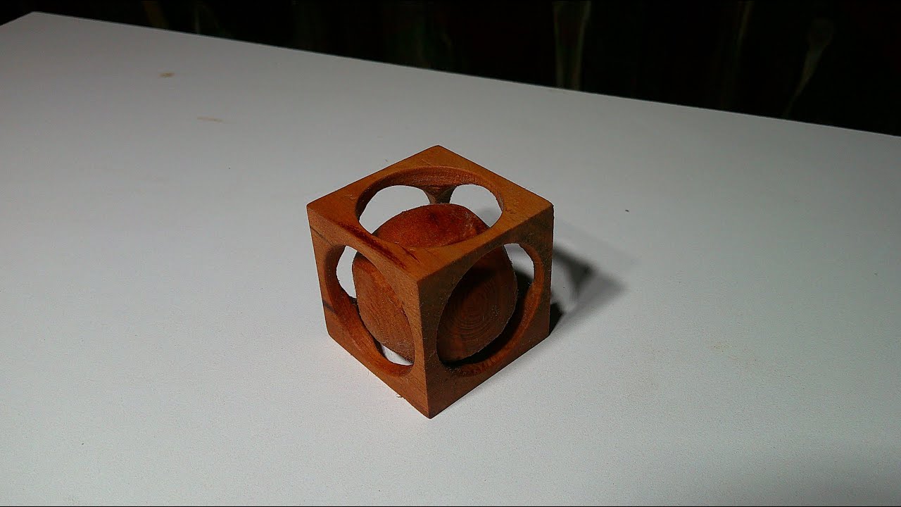 Beautiful wooden ball inside a cube