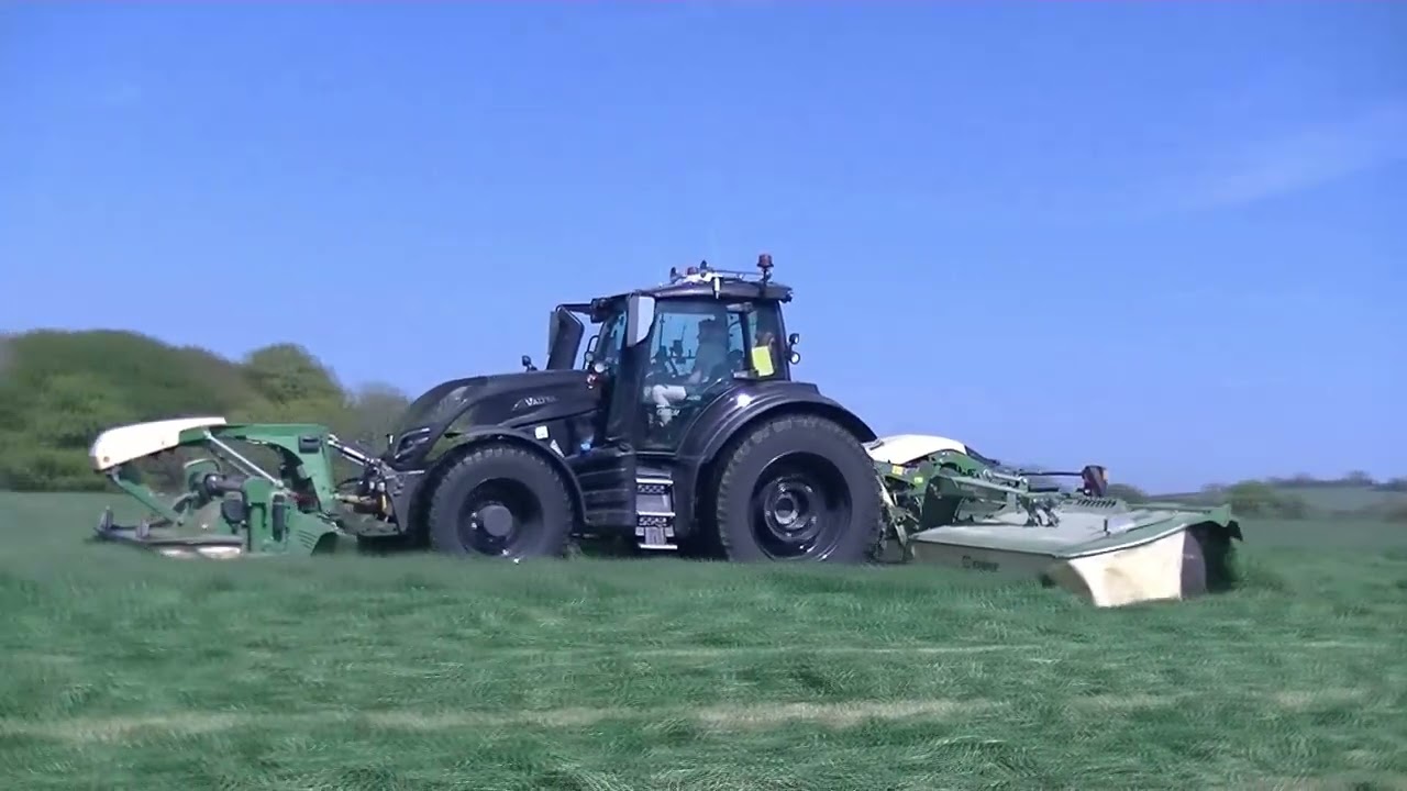 Valtra T255 mowing with Krone Triple mowers