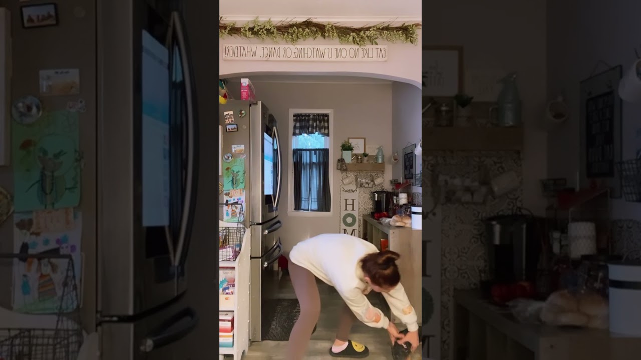 Woman struggles as her puppy is biting on her sock and won't let go!