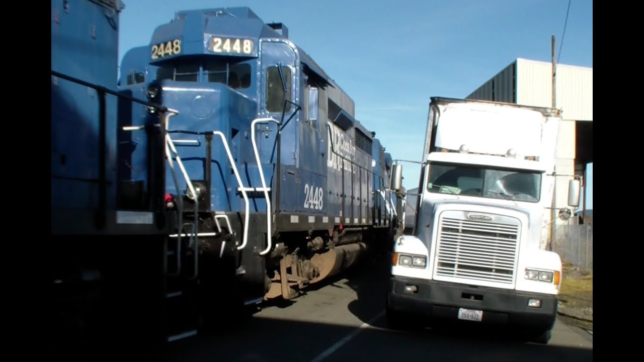 Railroad Running Down middle of BUSY Port Street ! Ex BNSF Santa Fe GP30 !  Street Running !