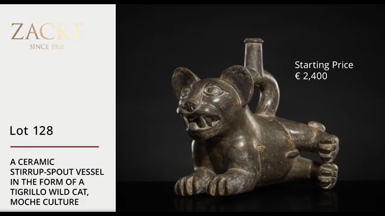 Lot 128: A CERAMIC STIRRUP-SPOUT VESSEL IN THE FORM OF A TIGRILLO WILD CAT, MOCHE CULTURE