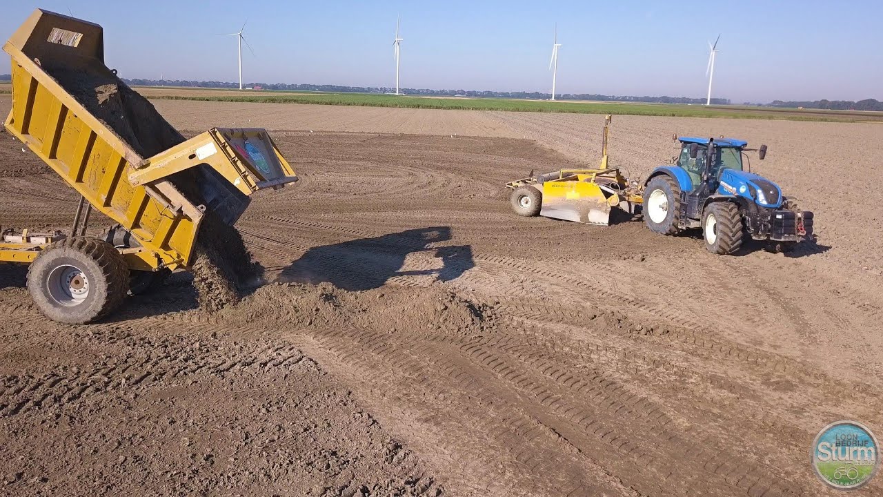 Contractor Sturm-Jacobs leveling the ground with dumpers and grading box