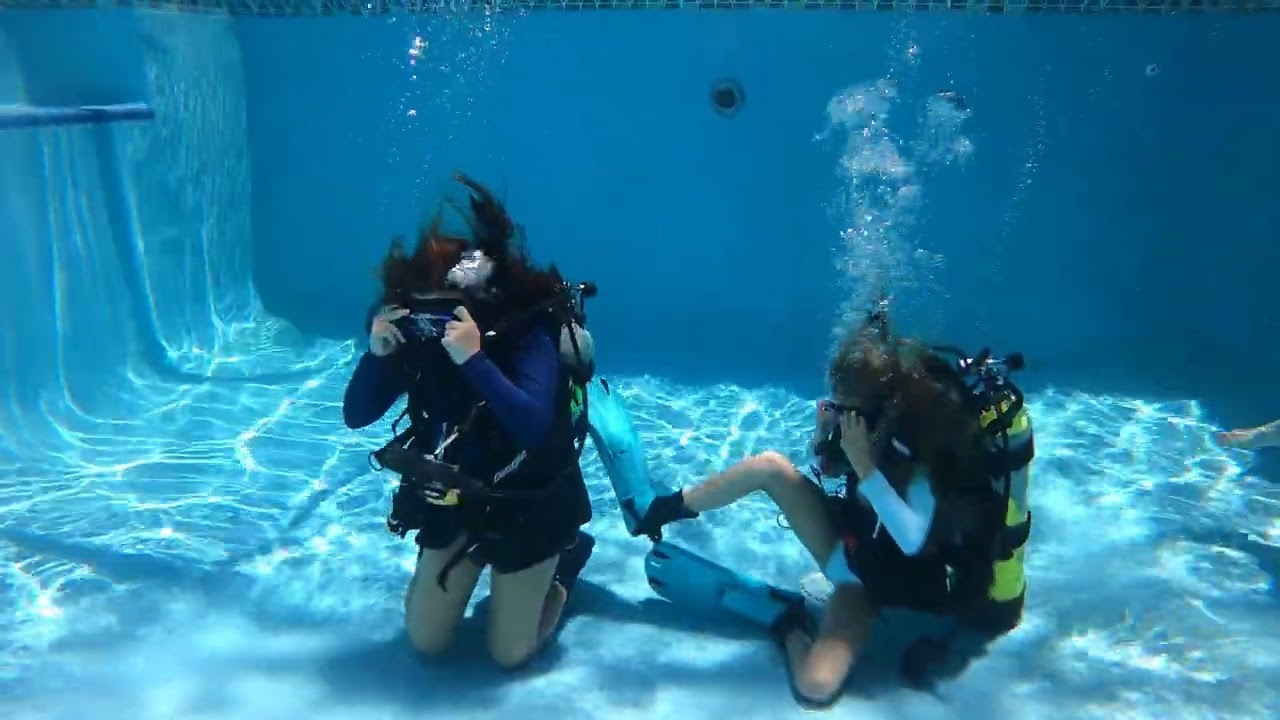 The Dive Girls practicing dive skills in the pool