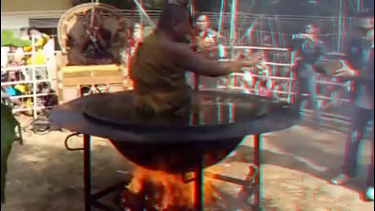 Thai monk practising his religious through meditation and is sitting in a bowl full of oil