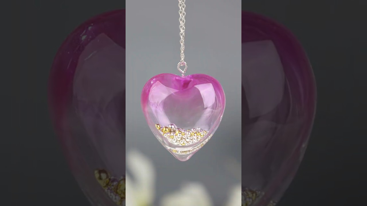 💖 Heart-shaped UV resin pendant with shimmering gold and silver beads, making every detail sparkle!