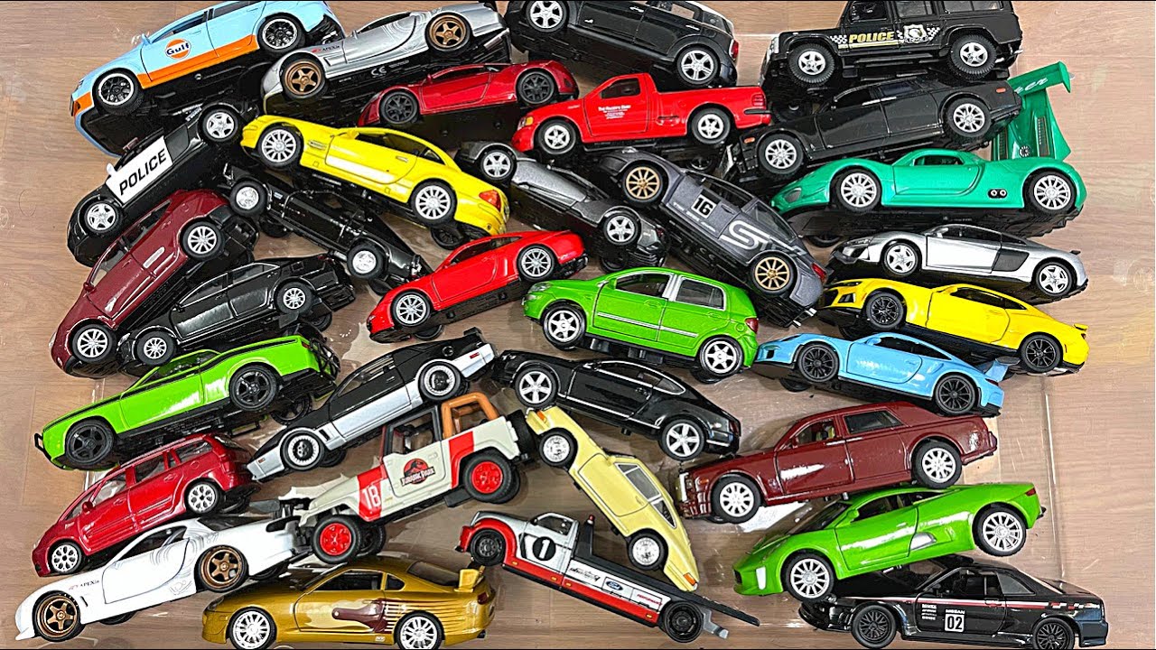 Box full of RMZ City branded diecast cars being observed in hands - 4K Video