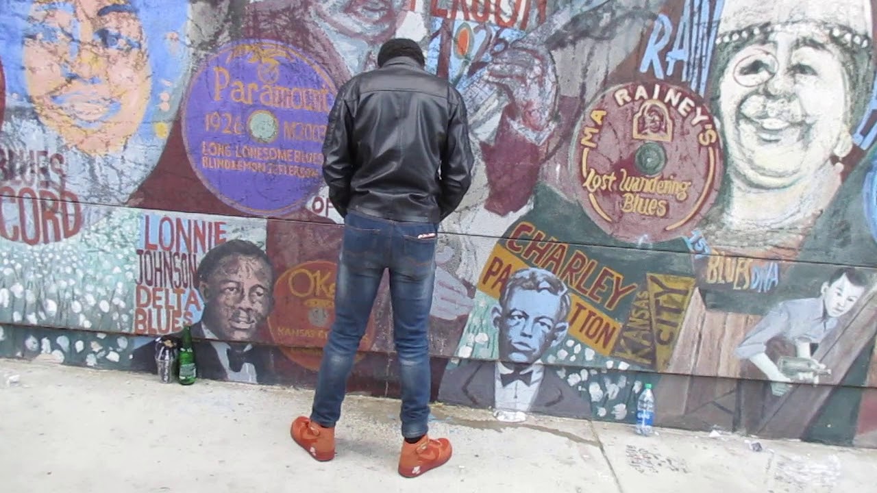Drunk homeless man peeing on Lonnie Johnson mural in Hollywood during rush hour traffic