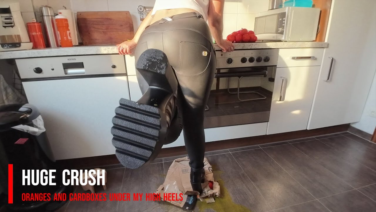 Stepping on a oranges with high heels 