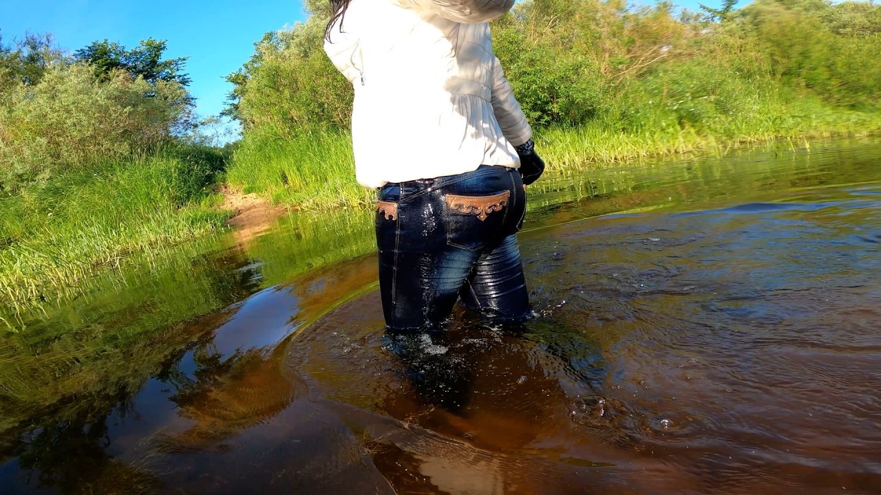 wet high leather boots, wet jeans and a wet short jacket in deep water