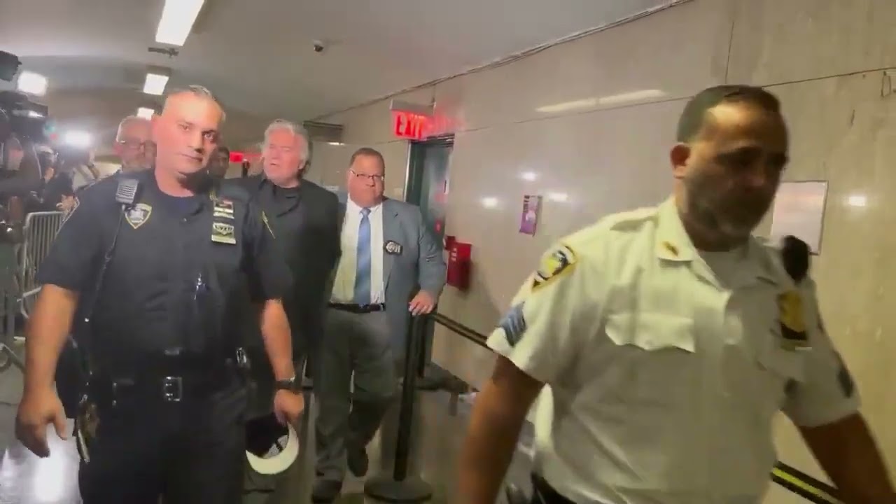 Steve Bannon does a perp walk in handcuffs